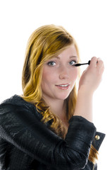 Young girl applying Mascara
