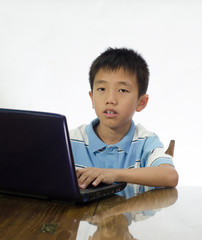 The boy do homework on  laptop
