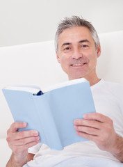 Mature Man Holding Book
