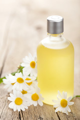 Obraz na płótnie Canvas essential oil and chamomile flowers