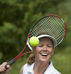 Female tennis player with racquet and ball