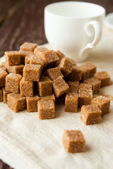 bunch of raw sugar and white cup