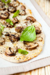 thin pizza with mushrooms and cheese, pita