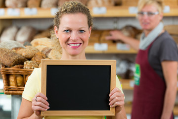 shop assistant with a billboard