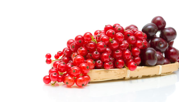 red currant and cherry, close-up on white background