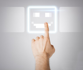 hand touching virtual screen with smile button