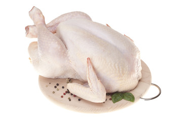 Fresh chicken on wooden board with spices 