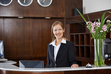 Happy female receptionist at hotel