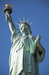 Fototapeta premium Statue of Liberty closeup blue sky background