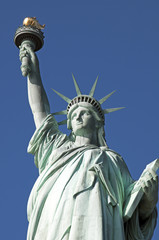 Statue of Liberty closeup blue sky background