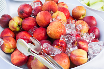 Fresh natural ripe peaches with ice cubes