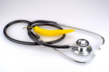 A stethoscope with a yellow chili