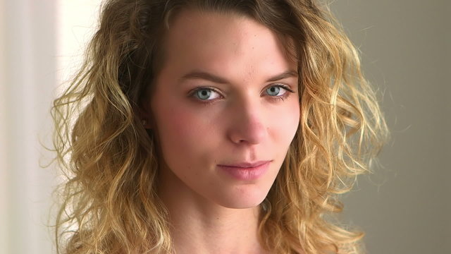 Close-up of blonde woman with curly hair