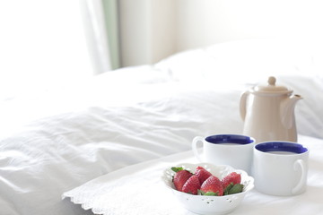 coffee and strawberry on bed side for home interior image