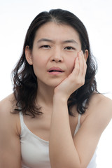 Asian woman is having toothache in white background