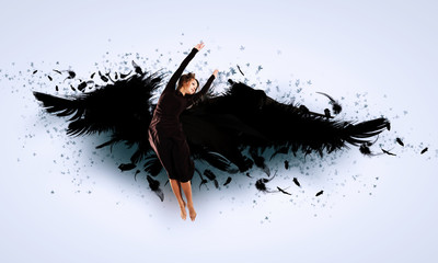 Woman floating   on dark wings