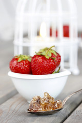 Fresh ripe strawberries in white ceramic bowl