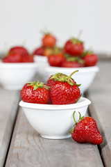 Fresh ripe strawberries in white ceramic bowl