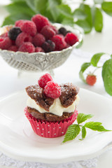 Chocolate muffins with raspberries and cream.