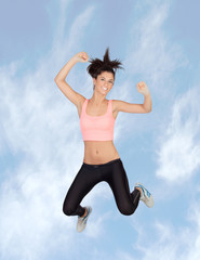 Attractive brunette girl with fitness clothing jumping