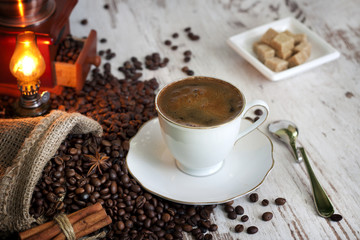 Cup of coffee on vintage white planks abstract still life