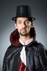 Magician in the dark room with wand