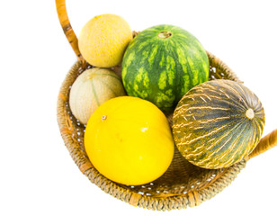 A variety of melons and honey dews in a basket