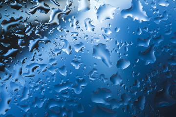 Fresh background of water drops on blue surface