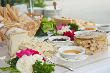buffet table with cheese, honey and jam