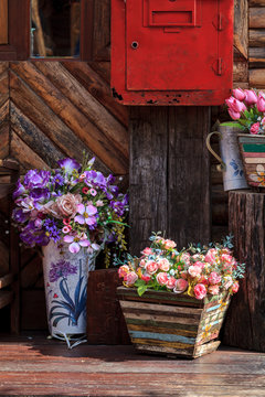 different flowerpots as decoration of countryside house