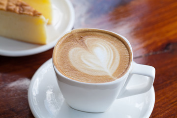 Cup of latte coffee with cake