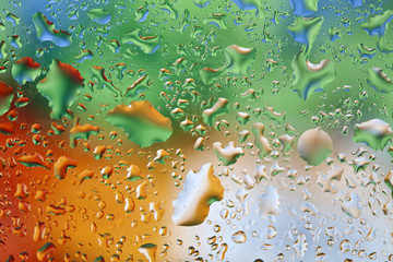 Fresh background of water drops on colorful surface