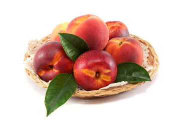 Fototapeta na wymiar Fresh peaches and nectarines in a basket isolated on a white bac