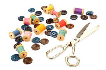 Colorful buttons, spools of thread and tailoring scissors.