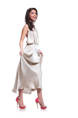 beauty woman holds dress and looks up