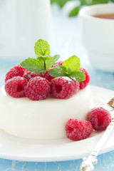 Vanilla panna cotta with raspberries.