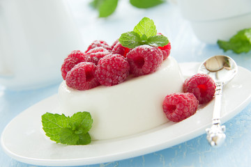 Vanilla panna cotta with raspberries.