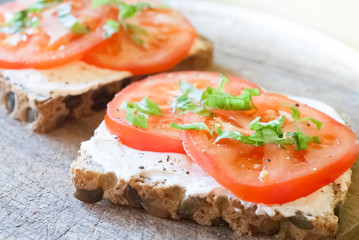 Cereal bread slice with tomato and ricotta