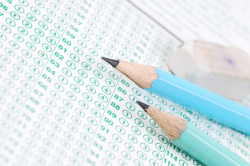 Pencils on blank test sheet close up