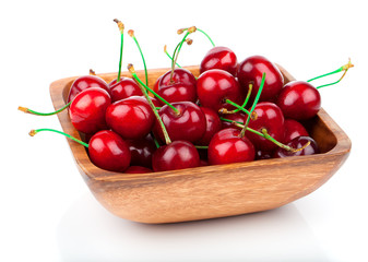 cherry berry in wooden bowl, isolated on white background