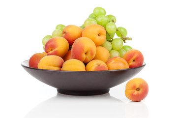 Apricots fruit on a bowl, isolated on white background