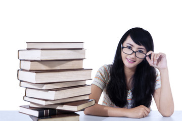 Beautiful female nerd student and books - isolated