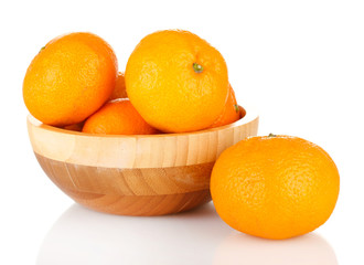 Tasty mandarines  in wooden bowl isolated on white