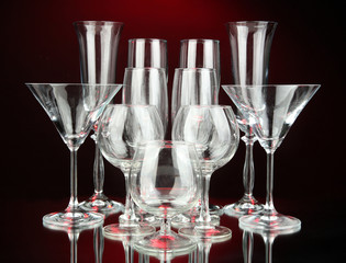 Cocktail and wine glasses, on dark red background