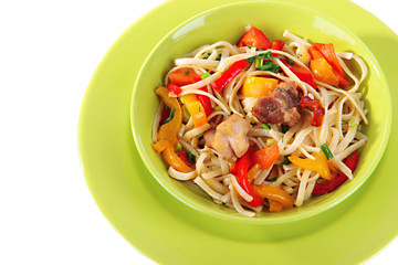 Noodles with vegetables on plate isolated on white
