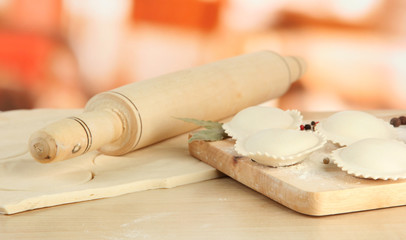 Raw dumplings and dough, on wooden table