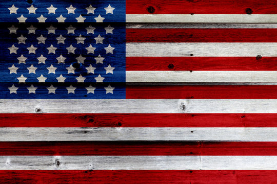 Old Painted American Flag on Dark Wooden Fence