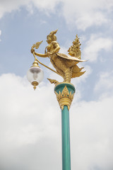 Fototapeta na wymiar Light pole decorated with mythical half-bird half-woman