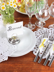 Table setting with chamomiles on wooden table background