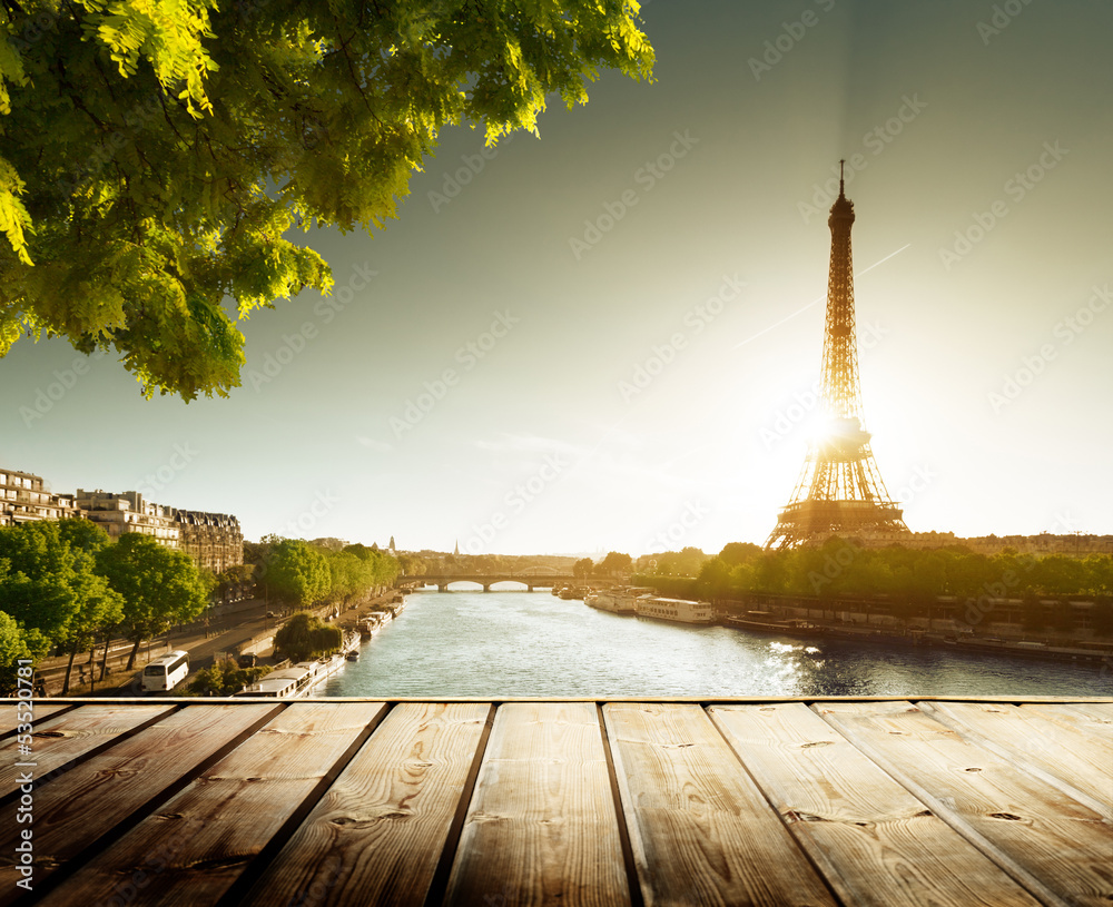 Aufkleber background with wooden deck table and eiffel tower in paris